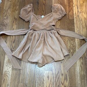 Chic Mable Tan Jumpsuit with crisscross open midriff with tie back.